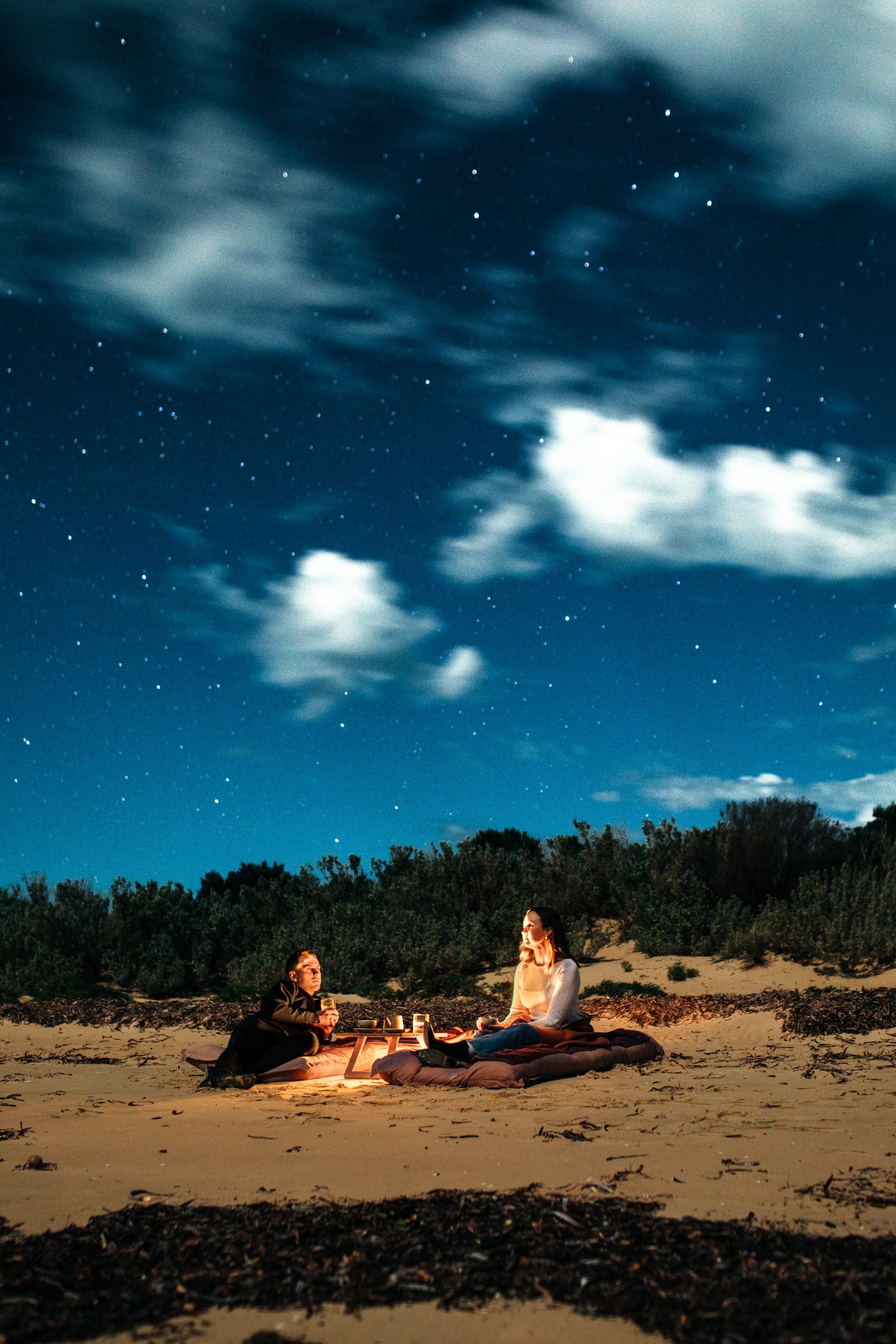 Stargazing Couple on a beach stargazing romantic setting for a proposal